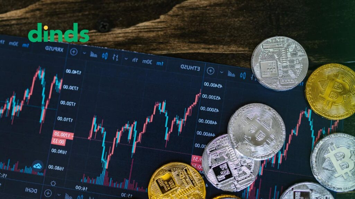 criptomoedas em cima de um gráfico de linhas